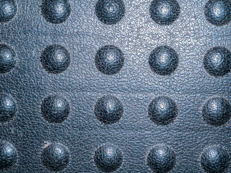 Texture of a black plastic surface with bulges. Black plastic. Background image. Place for your...