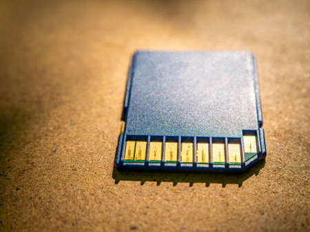 A closeup of a memory card lying on the table. Technology. Memory medium. Background image. Place for your text.の写真素材