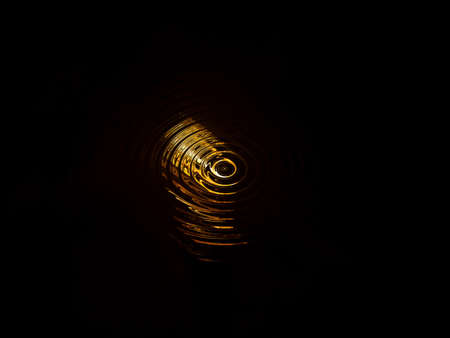 Abstract illustration of golden spirals on a black background. Golden reflections of water on a black background. Fantastic illustration. Space. Background image. Place for text. Poster. Booklet.の写真素材