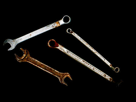 Hand tools metal wrenches on a black background. Hand-held locksmith tools. Wrench. Tighten screws...