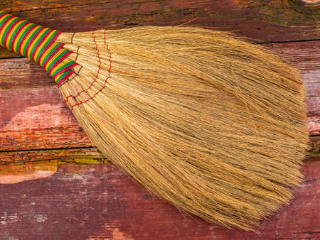 Wicker broom made of sorghum for indoor sweeping. Broom for sweeping the floor. House cleaning. Cleaning of office premises. Cleanliness and tidiness. Cleaning of the territory. Tool.の写真素材