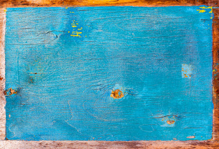 Faded texture of a wooden surface painted in blue. Peeling blue paint. Bough of a tree. Wood plywood texture. Aging process. Background image. Place for text. Cracks. Poster.の写真素材