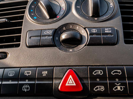 Plastic car control panel with buttons and knobs.