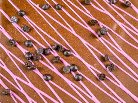 Chocolate cake with pink fruit cream on a black background. Dessert is chocolate. Sponge cream cake....