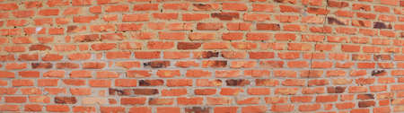 Texture of a red brick wall with cement joints. Old brick. Brickwork. Cement mortar. Construction...