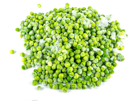 Frozen green peas vegetable on a white plate. Frozen vegetables. Green peas. Food in the refrigerator. Food storage. Vegetarian food. Harvest storage. White background.の写真素材