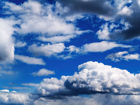 White cloud against blue sky in sunlight.の写真素材