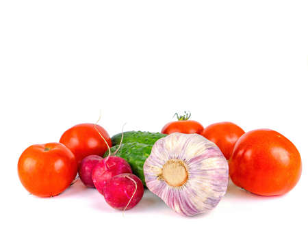 Head of garlic with cucumbers and tomatoes on a white background.