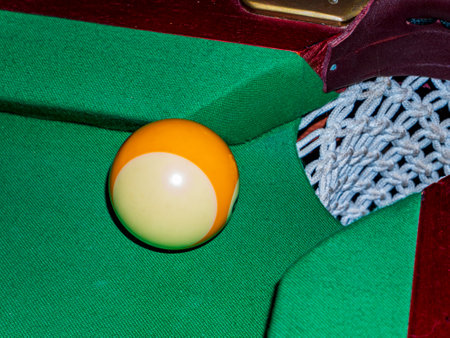 Ball near the pocket of the billiard table. Shoot a ball. The pocket of the billiard green table....