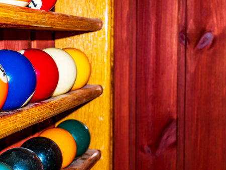 Colored billiard balls on a wooden shelf. Billiard ball. Wooden shelf. Numbered balls. Gambling....