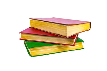 A stack of old books with colored covers. Books for reading. Old book. Book page yellow paper. Isolated on white background. Paper product. Read literature. Background image.の写真素材