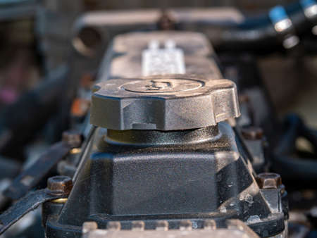 Filler cap for filling engine oil into a car engine.の写真素材