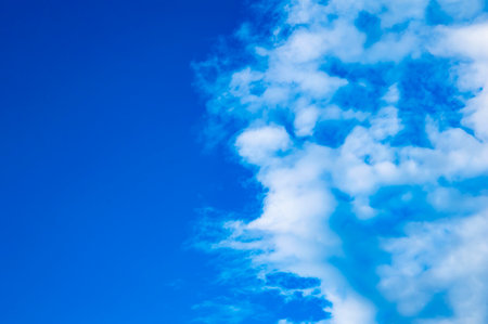 White cumulus clouds against the blue sky.の写真素材