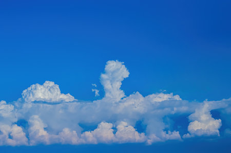 White cumulus clouds against the blue sky.の写真素材