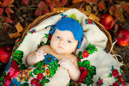 Portrait of cute newborn baby in a funny knitted hatの写真素材