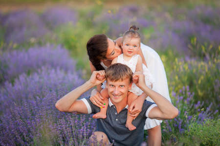 Happy young family with children having fun outdoors.の写真素材