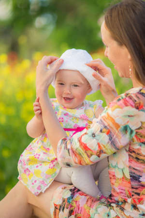 Happy woman and child on the poppy meadow.の写真素材