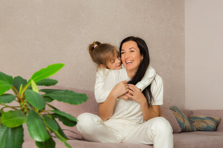 Mother and her daughter playing and hugging. Happy mothers day.の写真素材