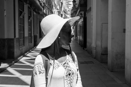 young tourist woman enjoying a visit at the entrance of the old Kasbah on a sunny dayの写真素材