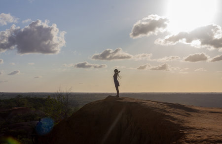 Young woman standing on a rock with beautiful landscape