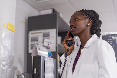 Close up of medical officer speaking on the phone in a hospitalの写真素材