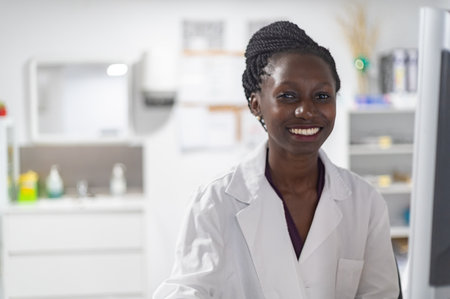 Young medical officer smilling next to her work spaceの写真素材