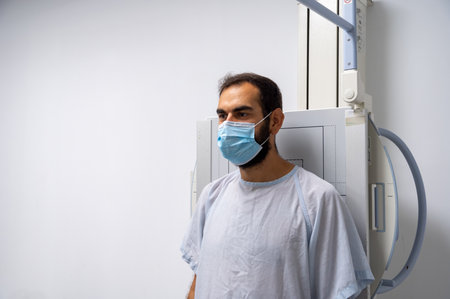 A patient standing for a radiology sessionの写真素材