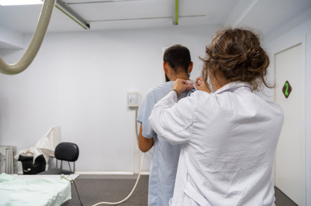 A patient standing for a radiology sessionの写真素材
