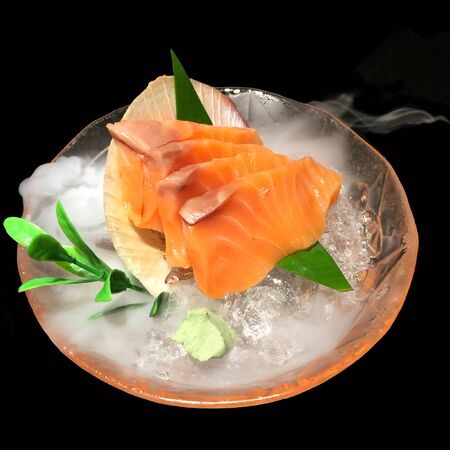 Salmon sashimi on ice to cool off so much smoke on the white backgroundの写真素材