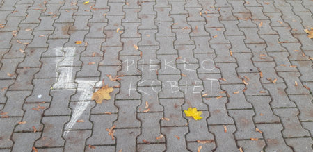 Warsaw, Poland, October 29, 2020: Pro-choice symbol of lightening bolt and the words PiekÅo Kobiet meaning Women's Hell written with chalk on the streetのeditorial素材