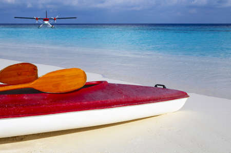 Paddle red boat is on a sandy beach