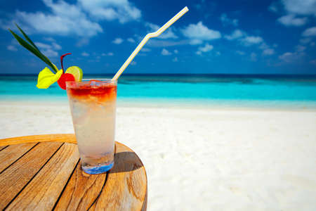 Refreshing cocktail on a beach tableの写真素材