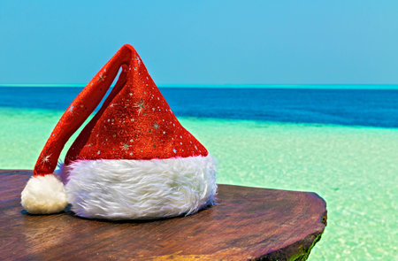 Santa hat is on a beach table, Maldives, The Indian Oceanの写真素材