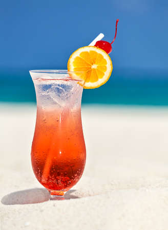 Glass of cocktail is on sandy coral  beach, Maldives, The Indian Oceanの写真素材