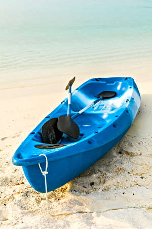 Paddle blue boat is on sandy beach, Maldivesの写真素材