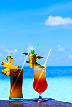 Two glasses of drink are on a beach table (Maldives, The Indian Ocean)の写真素材