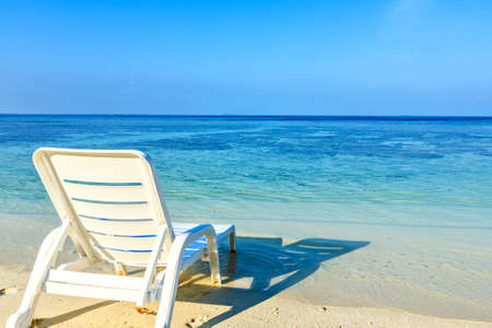 Armchair are waiting you on a morning sandy beach in the Indian Ocean, Maldivesの写真素材
