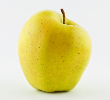 Isolated yellow apple on whiteの写真素材