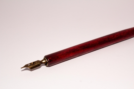 A old inkpen in front of a white backgroundの写真素材