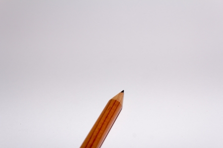 a plain simple pencil in front of a white backgroundの写真素材