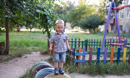 The boy is showing emotions. The boy is angry. The child plays in the playground.の写真素材
