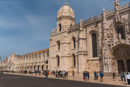 A side view of the Jeronimos Monastery (Mosteiro dos Jeronimos), where a large crowd tourists are waiting to enter and is one of the main attractions and popular landmark in Lisbon, Portugalのeditorial素材