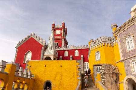 Tourists walking about and admiring the brightly colored walls of the Pena Palace (PalÃ¡cio da Pena), a UNESCO world heritage site in Sintra, Portugal.のeditorial素材
