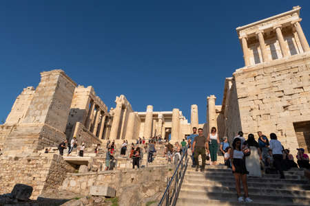 Athens, Greece - 13th October, 2019: Tourists going in and out of the entrance to the Acropolis called the Propylaea, one of the most iconic and historical sites in Athens, Greece.のeditorial素材