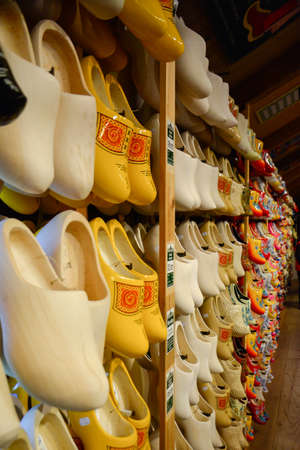 Display of colorful and traditional Dutch wooden shoes, known as Clogs, neatly placed in rows, on a...