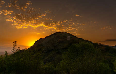 Dramatic sunset behind the hill at the town of Kakheti in Georgia country. Bright glow from the sun.の写真素材