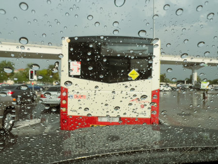 Selective focus and motion blur of raindrops on the windshield of a vehicle in traffic during a downpour in Dubai, Unite Arab Emirates.の写真素材