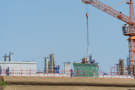 Dubai, United Arab Emirates - 14th April, 2023 : Laborers busy at work at a new construction site.