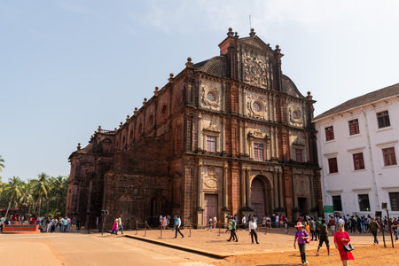 Old Goa, India - 19th December, 2022 : Exterior view of the Basilica of Bom Jesus with tourists enjoying the sites of the most famous tourist attraction.のeditorial素材