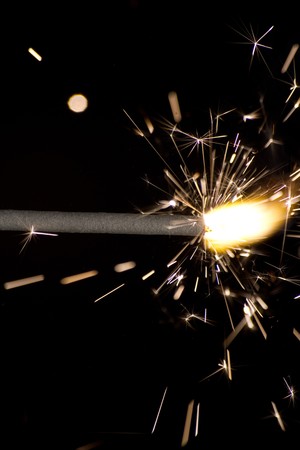The picture shows a sparkler on black background .の写真素材